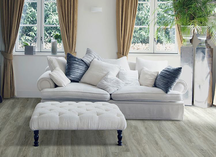 plush grey couch on top of vinyl flooring